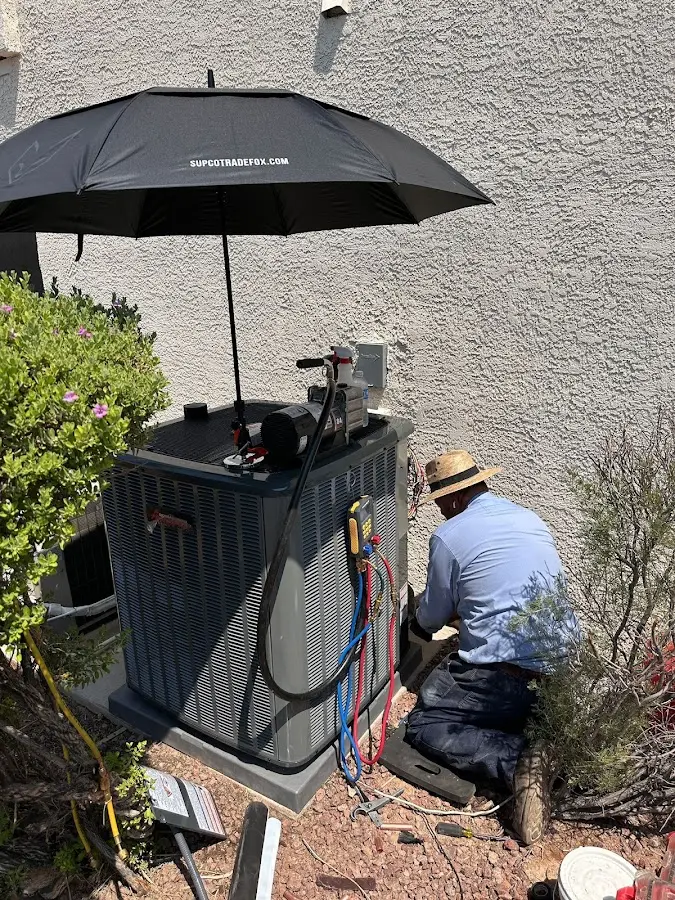 HVAC technician performing outdoor AC maintenance in Newstead